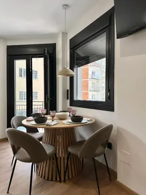 a dining room with a table and chairs and a window at Lemos Agra in Monforte de Lemos