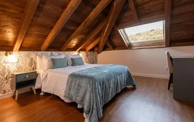 a bedroom with a bed and a window at La Rectoral de Besullo in Besullo