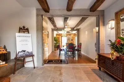 a hallway with a table and chairs in a house at La Rectoral de Besullo in Besullo