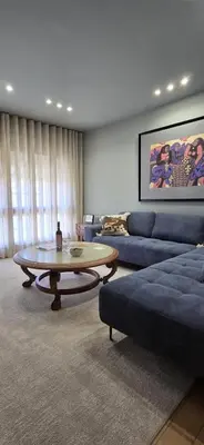 a living room with a blue couch and a coffee table at Maruja Rural 2 in Sober