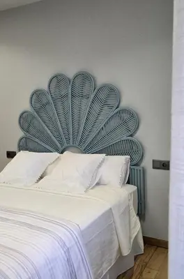 a bedroom with a bed with a blue headboard at Maruja Rural 2 in Sober