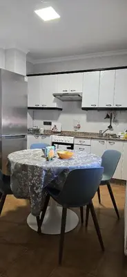 a kitchen with a table with chairs and a counter at Maruja Rural 2 in Sober