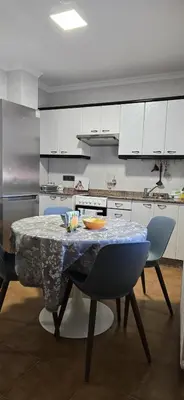 a kitchen with a table and chairs in a kitchen at Maruja Rural 2 in Sober