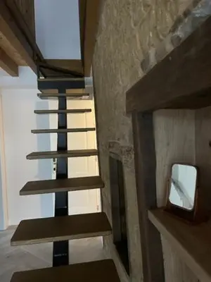 a spiral staircase in a room with a mirror at La Higuera in Cacabelos
