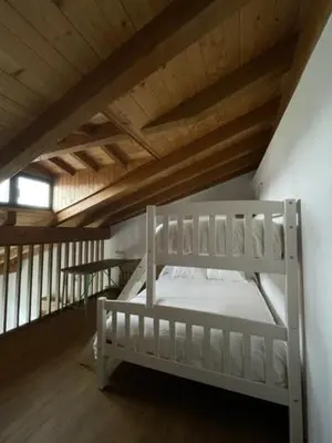 a bedroom with two bunk beds in a attic at La Higuera in Cacabelos