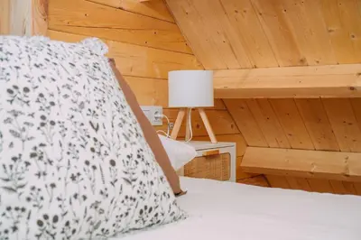 a bedroom with a bed and a lamp on a table at Cabañas de Allariz - Cabaña 5 in Allariz