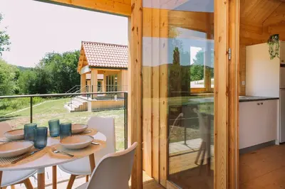 a kitchen and dining room with a table and chairs at Cabañas de Allariz - Cabaña 5 in Allariz