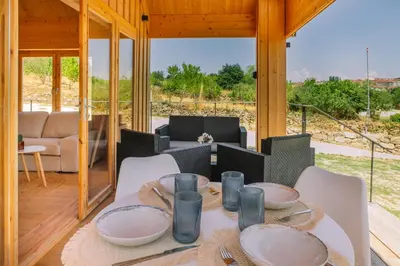 a dining room with a table and chairs in a house at Cabañas de Allariz - Cabaña 2 in Allariz