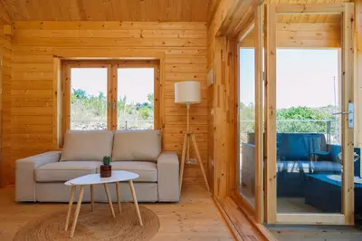 a living room with a couch and a table at Cabañas de Allariz - Cabaña 2 in Allariz
