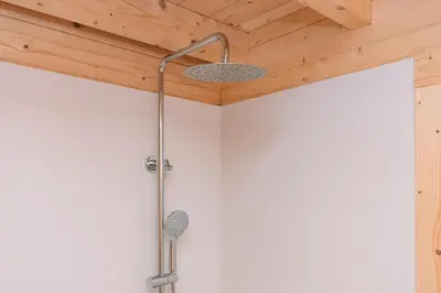 a shower in a bathroom with a wooden ceiling at Cabañas de Allariz - Cabaña 3 in Allariz