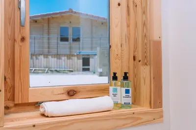 a window with a towel and two bottles on a shelf at Cabañas de Allariz - Cabaña 3 in Allariz