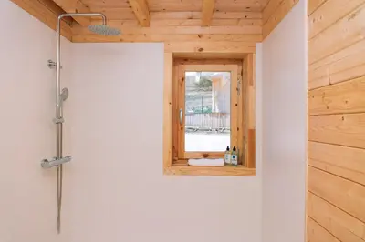 a bathroom with a shower and a window at Cabañas de Allariz - Cabaña 3 in Allariz
