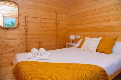 a bedroom with a bed with two towels on it at Cabañas de Allariz - Cabaña 4 in Allariz