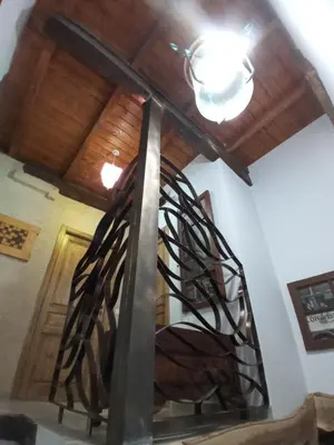 a metal spiral staircase in a room with a ceiling at Albergue la Medina de Camponaraya in Camponaraya