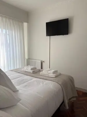 a bedroom with a bed with towels on it at Cardenal Centro in Monforte de Lemos