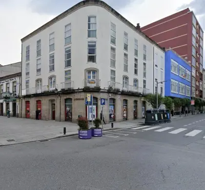 a large white building on the corner of a street at Cardenal Centro in Monforte de Lemos