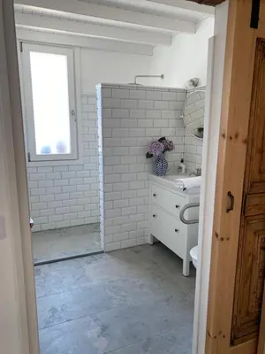 a bathroom with a toilet and a sink and a window at Casa costa de Lugo frente al mar in Nois