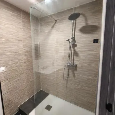 a shower with a glass door in a bathroom at Casa de Pedra in Melide