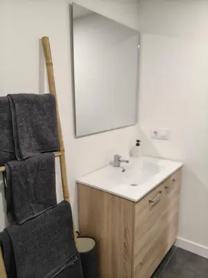 a bathroom with a sink and a mirror at Casa de Pedra in Melide