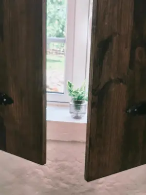 an open door with a potted plant in a window at Casa de Pedra in Melide