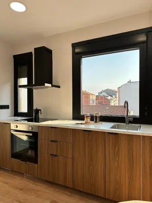 a kitchen with a sink and a large window at Lemos Nai in Monforte de Lemos