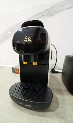 a black coffee maker sitting on a table at Chuspombo Apartamentos in Baralla