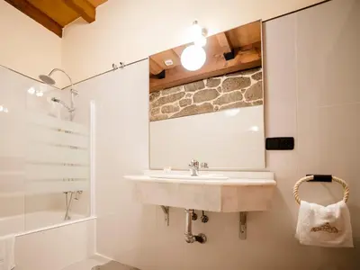 a bathroom with a sink and a mirror at Aldea Rural Pazos De Arenteiro in Pazos de Arenteiro