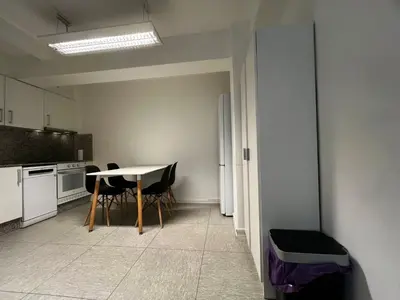 a kitchen with a table and chairs in a room at Luz y Calma junto a la Catedral in Santiago de Compostela