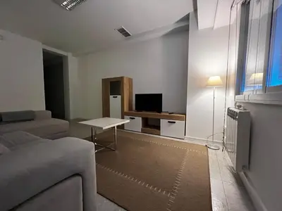 a living room with a couch and a table at Luz y Calma junto a la Catedral in Santiago de Compostela