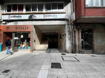 a person walking in front of a building at Luz y Calma junto a la Catedral in Santiago de Compostela