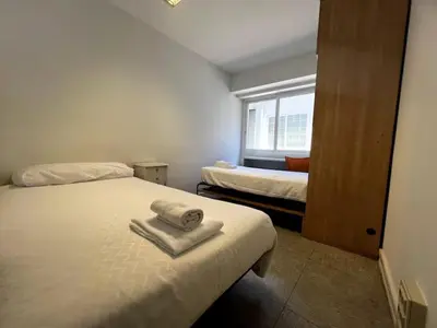 a room with two beds with towels on them at Luz y Calma junto a la Catedral in Santiago de Compostela