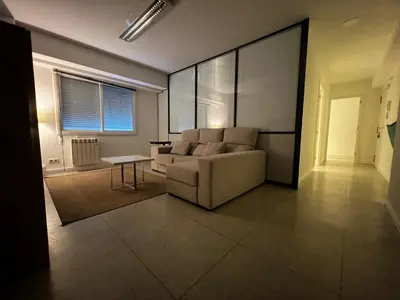 a living room with a couch and a table at Luz y Calma junto a la Catedral in Santiago de Compostela