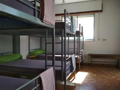 a room with four bunk beds and a window at Casa Do Marabillas in Portomarin