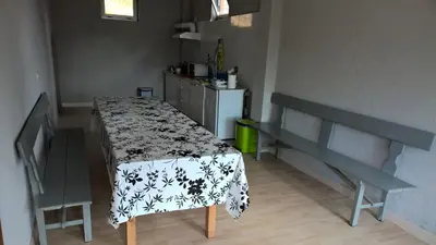 a kitchen with a table with a table cloth on it at Casa Do Marabillas in Portomarin