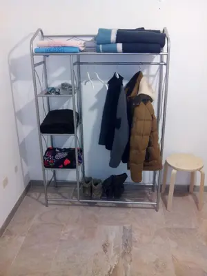 a walk in closet with a rack with clothes at Casa Do Marabillas in Portomarin