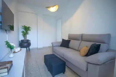 a living room with a couch and a table at Apartamento Río Sol in Sarria