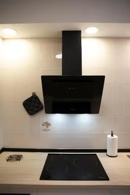 a kitchen with a black stove top oven at Apartamento Río Sol in Sarria