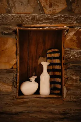 two white vases sitting on a wooden shelf at VUT La casita del Pajar in Vega de Espinareda