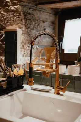 a kitchen counter with a sink with a sink at VUT La casita del Pajar in Vega de Espinareda