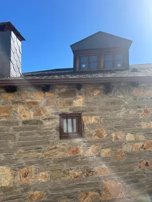 a stone building with two windows on it at VUT La casita del Pajar in Vega de Espinareda
