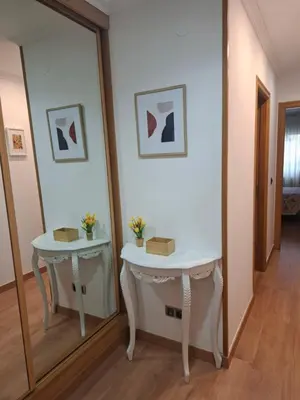 a mirror in a room with a table and a mirror at Apartamento Lugo Muralla in Lugo