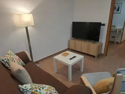 a living room with a couch and a flat screen tv at Apartamento Lugo Muralla in Lugo