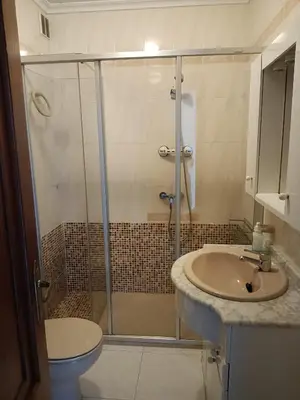 a bathroom with a shower and a sink and a toilet at En Foz en 1a línea de playa in Foz