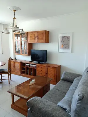 a living room with a couch and a table at En Foz en 1a línea de playa in Foz