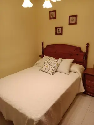 a bedroom with a white bed with two pillows on it at En Foz en 1a línea de playa in Foz