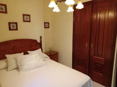 a bedroom with a bed with white pillows at En Foz en 1a línea de playa in Foz