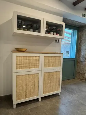 a kitchen with white cabinets and a window at A CASIÑA dos LARANXOS in Cenlle