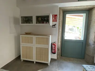 a room with a blue door and a window at A CASIÑA dos LARANXOS in Cenlle