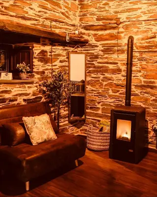 a living room with a couch and a fireplace at Casa Da Fragua in Samos