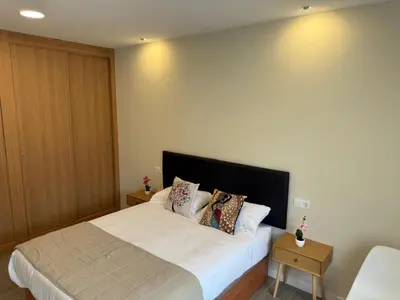 a bedroom with a large white bed with pillows at Pension Lugo FINGOI in Lugo